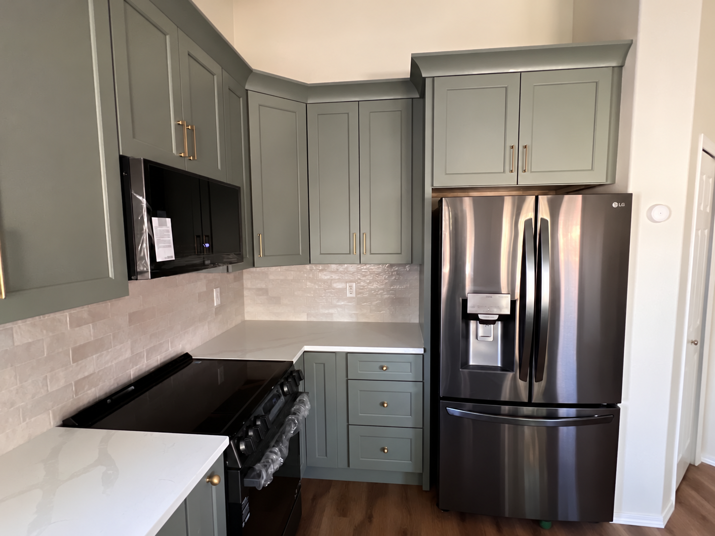 Colorado Springs kitchen remodel with sage cabinetry and stainless refrigerator