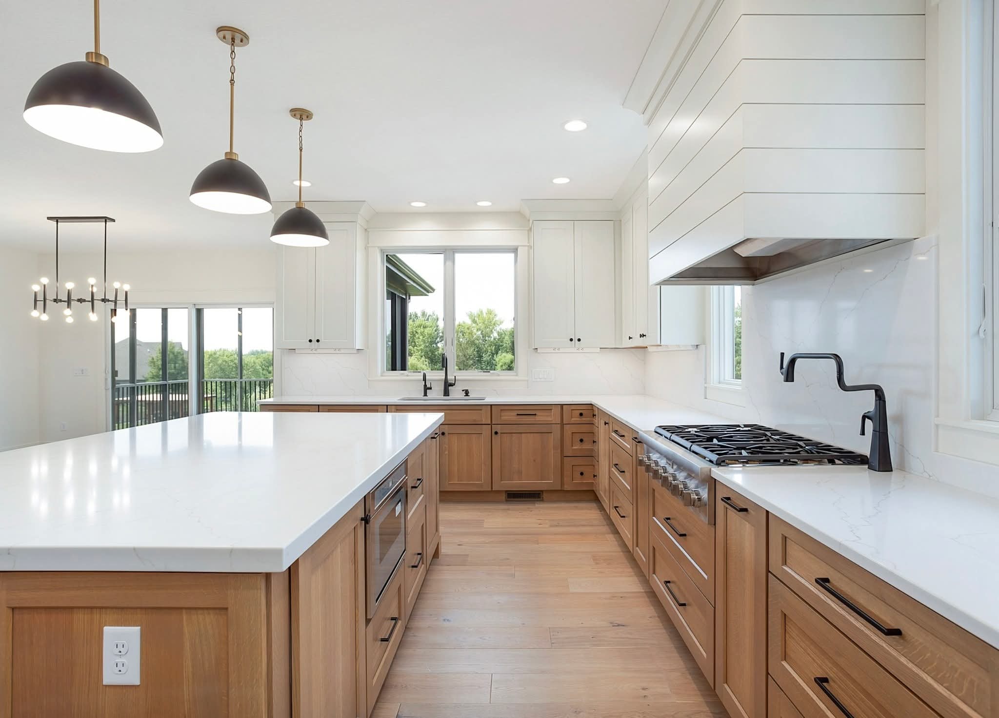 Cherry Hills Village kitchen — natural oak island with quartz countertop and matte black hardware