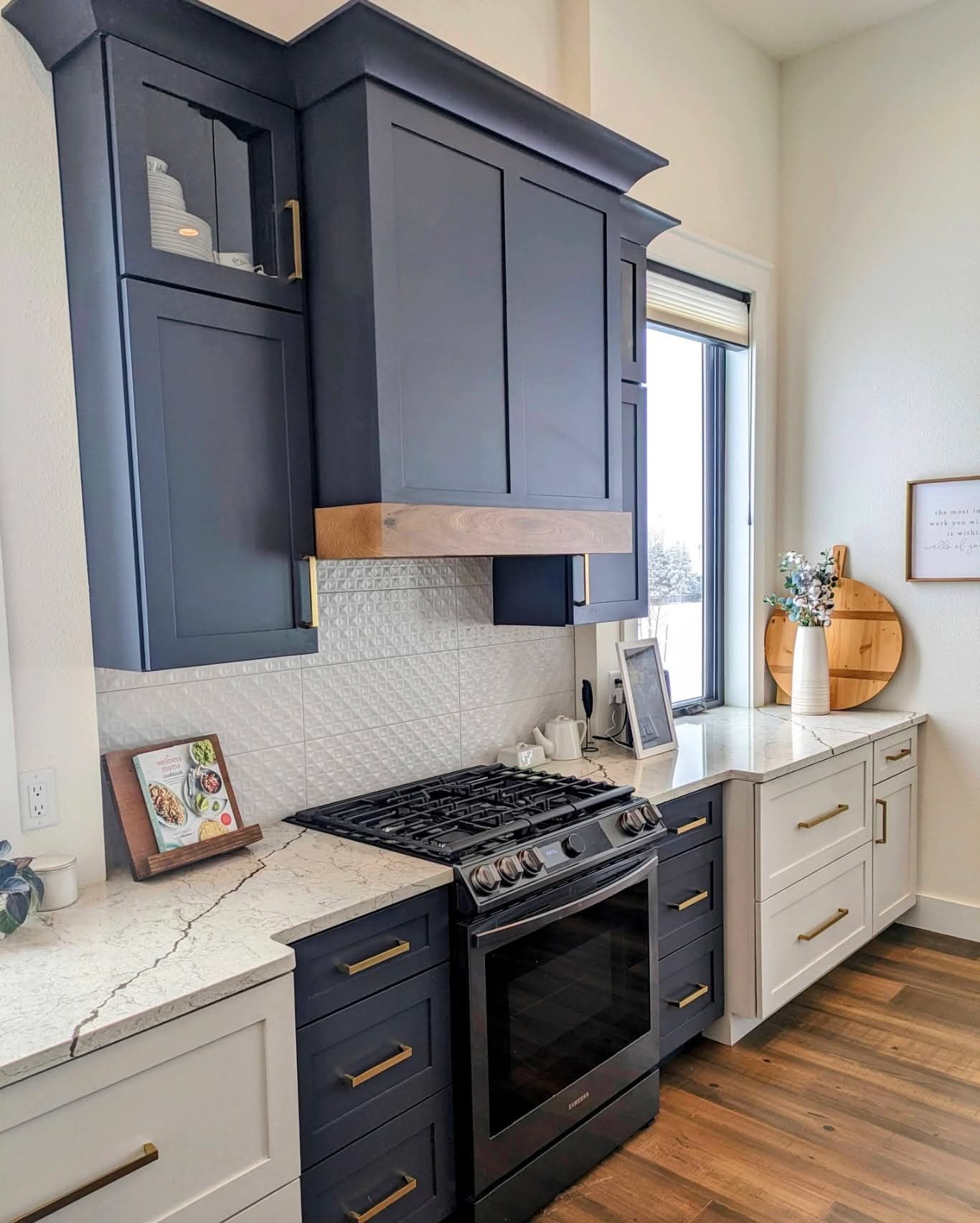 Highlands Ranch kitchen — white perimeter cabinetry and matte black hardware, upper angle