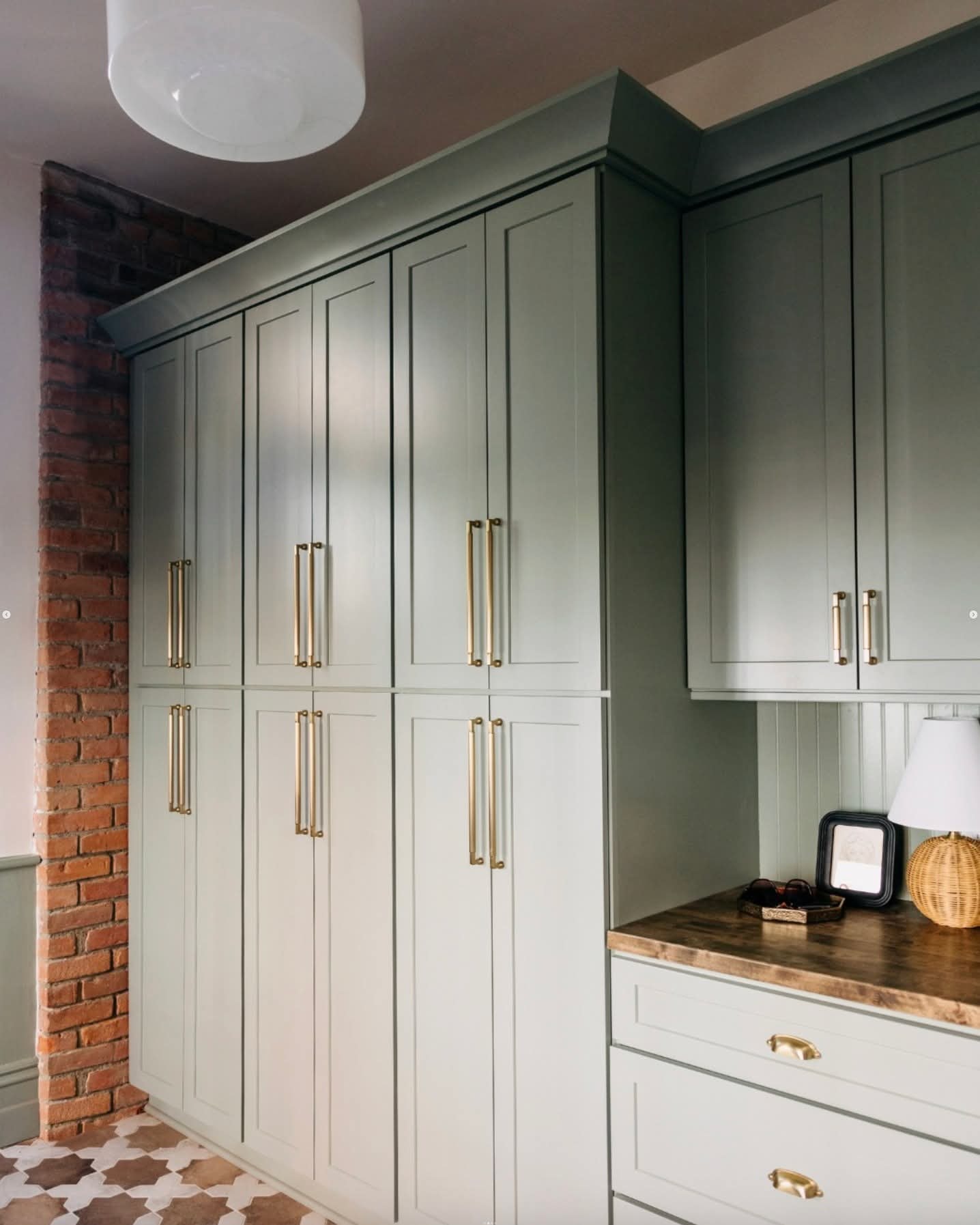 Cherry Creek kitchen — sage green built-in cabinetry with brass hardware detail